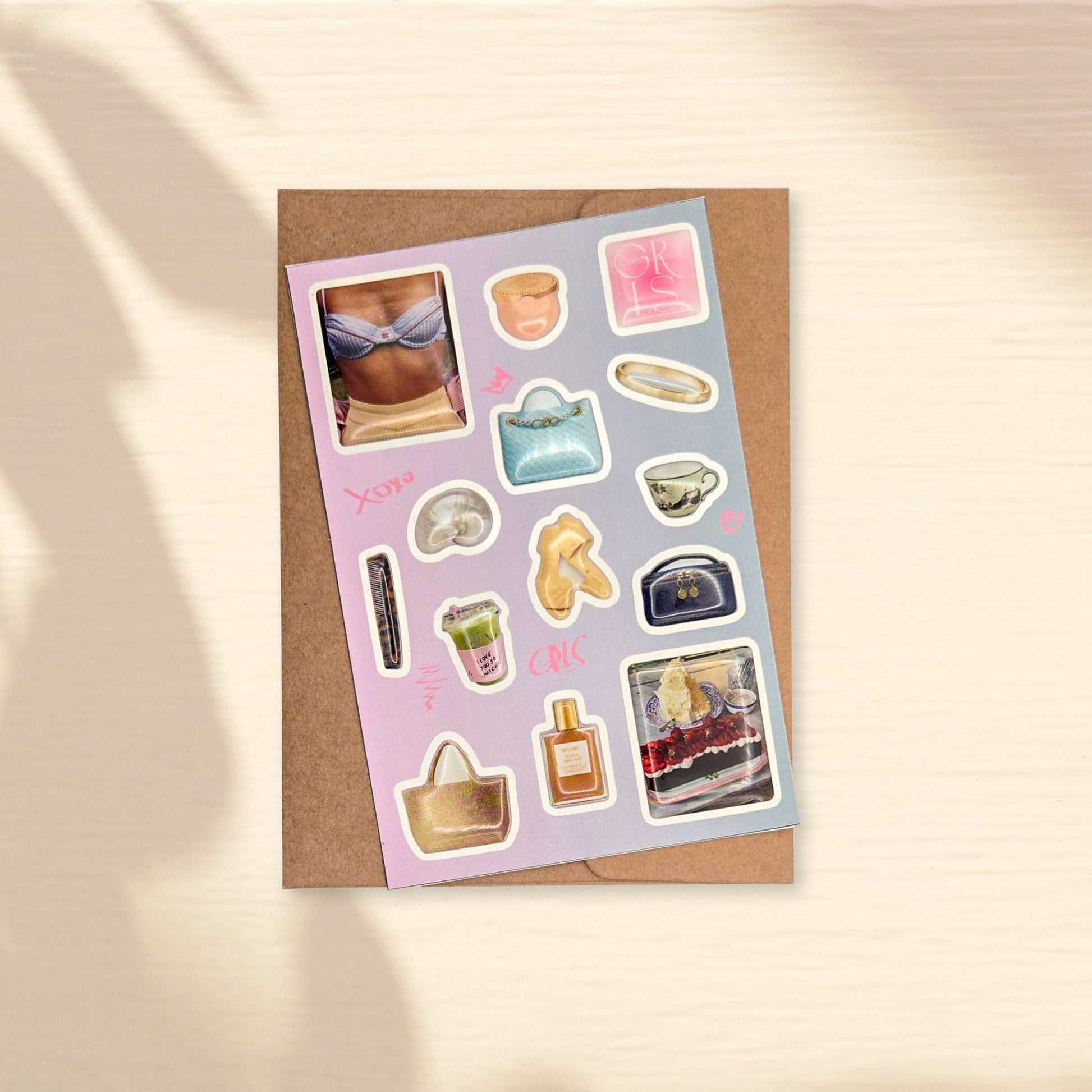 Glossy 3d domed sticker sheet with various fancy small images on a light purple background - handbags, shells, cosmetic bags, matcha, cake, bikini, comb