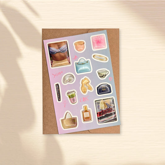 Glossy 3d domed sticker sheet with various fancy small images on a light purple background - handbags, shells, cosmetic bags, matcha, cake, bikini, comb