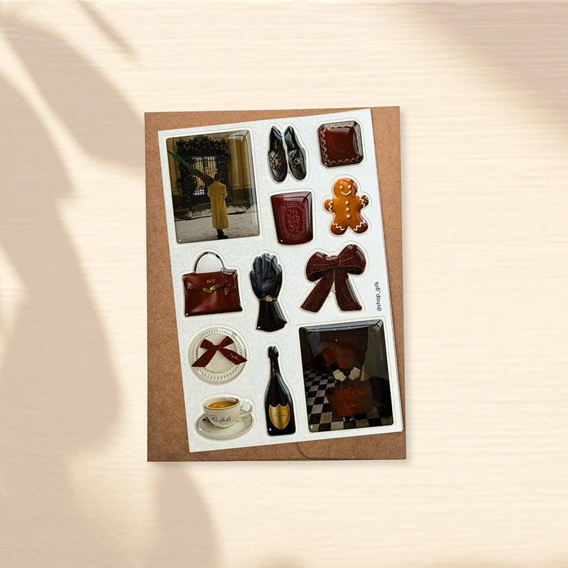 A curated 3D jewelry decal set celebrating the art of alpine Après-Ski. High-gloss, glass-like accents featuring iconic imagery of fine burgundy leather goods, vintage champagne, and a snowy winter manor. Sculpted with jewelry-grade resin to bring a touch of timeless warmth to your device.